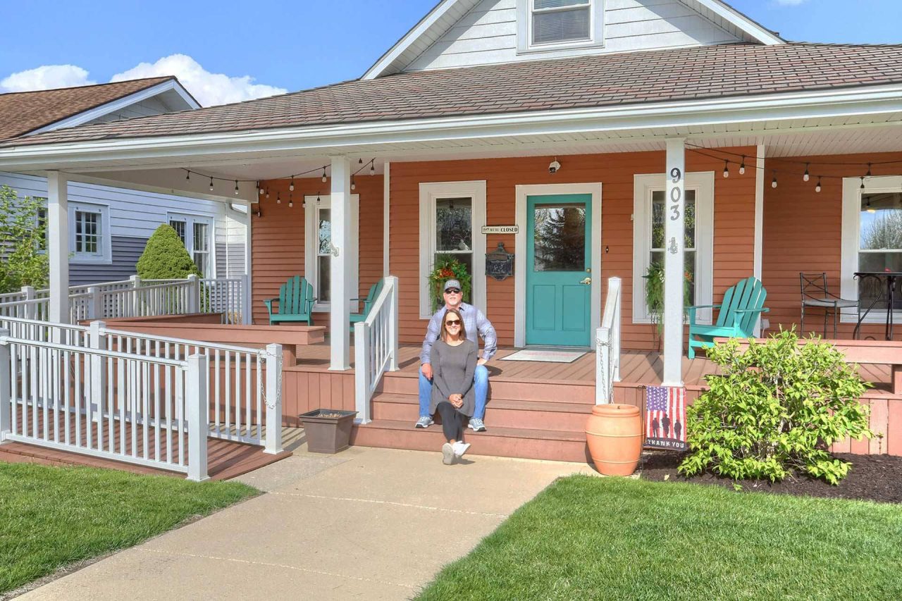 Exterior of Canal Street Market in Winona Lake, IN with the owners sitting on the porch.